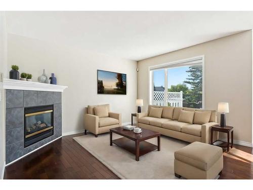 73 Rocky Ridge Heath Nw, Calgary, AB - Indoor Photo Showing Living Room With Fireplace