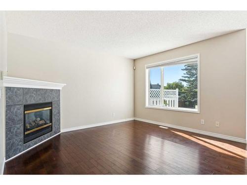 73 Rocky Ridge Heath Nw, Calgary, AB - Indoor Photo Showing Other Room With Fireplace