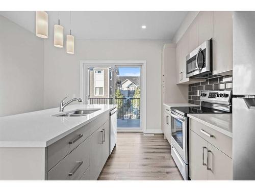 482 Canals Crossing Sw, Airdrie, AB - Indoor Photo Showing Kitchen With Double Sink