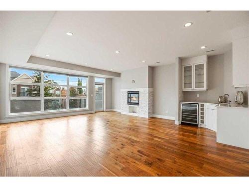 104-1804 34 Sw, Calgary, AB - Indoor Photo Showing Living Room With Fireplace