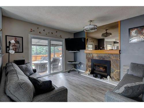 84 Riverside Way Se, Calgary, AB - Indoor Photo Showing Living Room With Fireplace