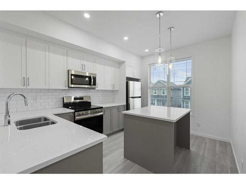 156 Copperleaf Way Se, Calgary, AB - Indoor Photo Showing Kitchen With Double Sink With Upgraded Kitchen