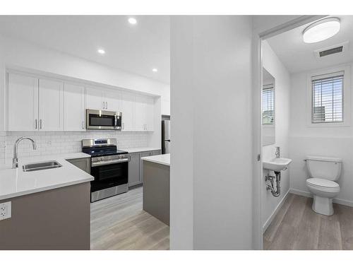 156 Copperleaf Way Se, Calgary, AB - Indoor Photo Showing Kitchen With Double Sink