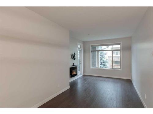 207-22 Auburn Bay Link Se, Calgary, AB - Indoor With Fireplace