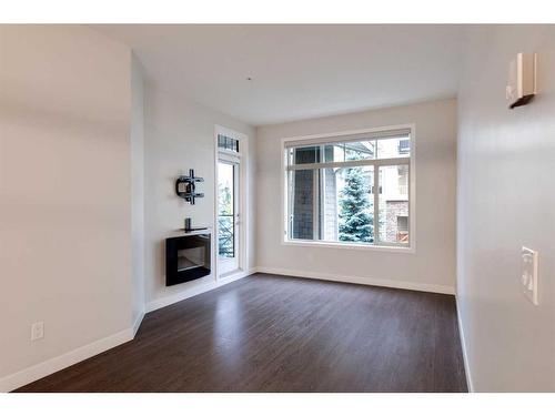 207-22 Auburn Bay Link Se, Calgary, AB - Indoor With Fireplace