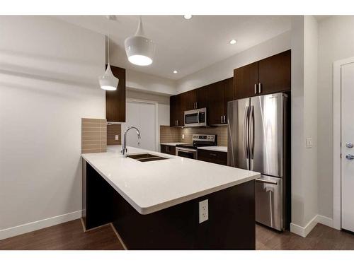 207-22 Auburn Bay Link Se, Calgary, AB - Indoor Photo Showing Kitchen With Double Sink With Upgraded Kitchen