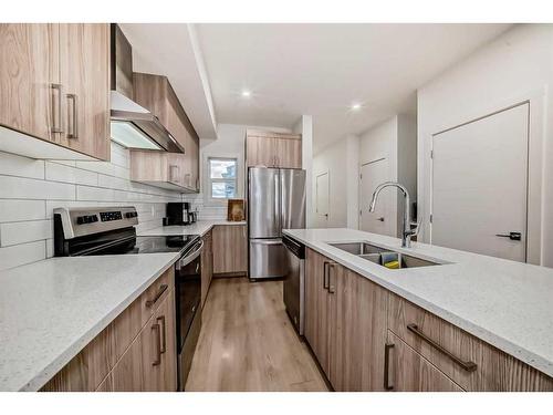 99 Saddlestone Drive Ne, Calgary, AB - Indoor Photo Showing Kitchen With Stainless Steel Kitchen With Double Sink With Upgraded Kitchen