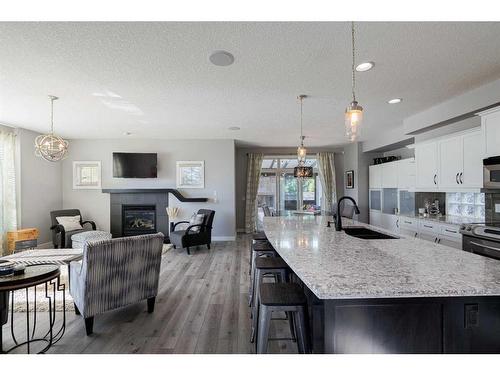 60 Tuscany Glen Park Nw, Calgary, AB - Indoor Photo Showing Kitchen With Fireplace With Upgraded Kitchen