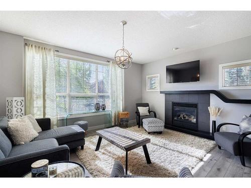 60 Tuscany Glen Park Nw, Calgary, AB - Indoor Photo Showing Living Room With Fireplace