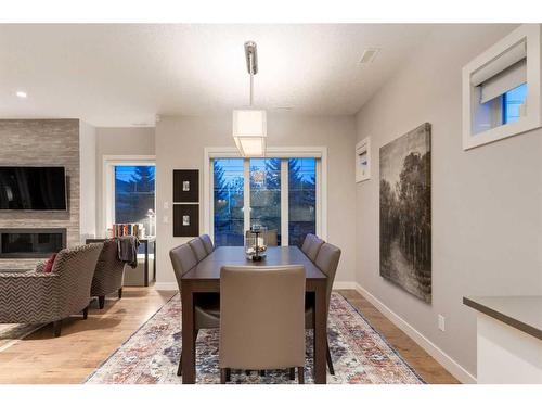 4-2432 30 Street Sw, Calgary, AB - Indoor Photo Showing Dining Room With Fireplace