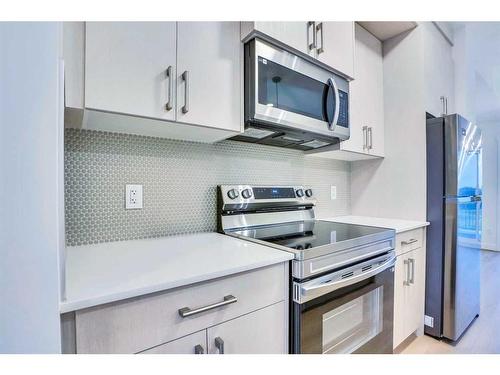 502-33 Merganser Drive West, Chestermere, AB - Indoor Photo Showing Kitchen With Upgraded Kitchen