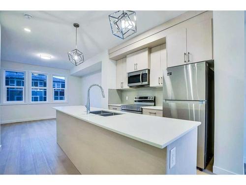 502-33 Merganser Drive West, Chestermere, AB - Indoor Photo Showing Kitchen With Stainless Steel Kitchen With Double Sink With Upgraded Kitchen