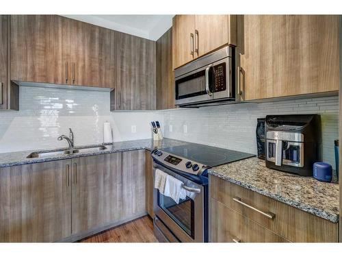 115-16 Sage Hill Terrace Nw, Calgary, AB - Indoor Photo Showing Kitchen With Stainless Steel Kitchen With Double Sink With Upgraded Kitchen