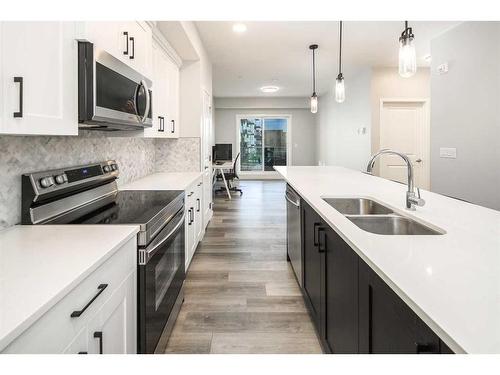 222-360 Harvest Hills Way Ne, Calgary, AB - Indoor Photo Showing Kitchen With Stainless Steel Kitchen With Double Sink With Upgraded Kitchen