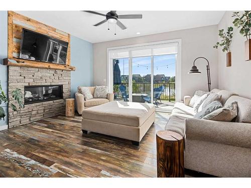 227 Reunion Green Nw, Airdrie, AB - Indoor Photo Showing Living Room With Fireplace