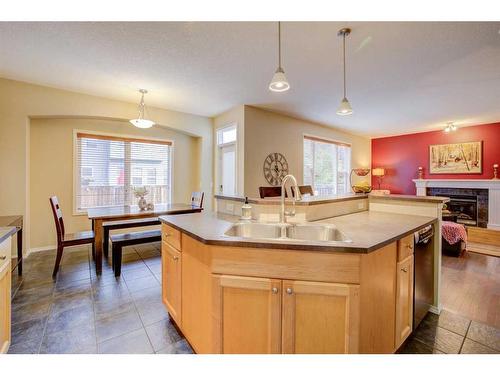 121 Bridlerange Circle Sw, Calgary, AB - Indoor Photo Showing Kitchen With Fireplace With Double Sink