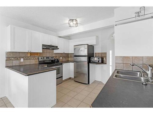 9416 Hidden Valley Drive Nw, Calgary, AB - Indoor Photo Showing Kitchen With Double Sink