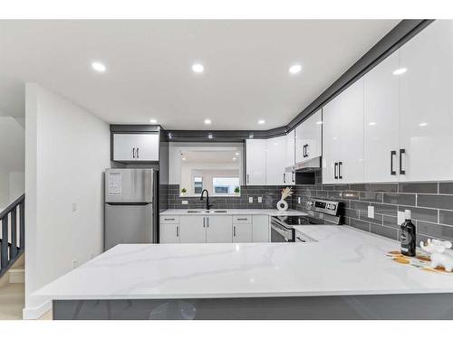 47 Kingsland Villas Sw, Calgary, AB - Indoor Photo Showing Kitchen With Double Sink With Upgraded Kitchen