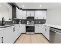 47 Kingsland Villas Sw, Calgary, AB  - Indoor Photo Showing Kitchen With Double Sink 