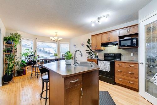 180 Silverado Way Sw, Calgary, AB - Indoor Photo Showing Kitchen With Double Sink