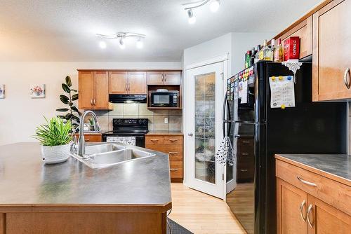 180 Silverado Way Sw, Calgary, AB - Indoor Photo Showing Kitchen With Double Sink