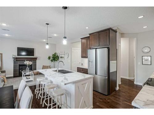 18 Chaparral Valley Place Se, Calgary, AB - Indoor Photo Showing Kitchen With Fireplace With Stainless Steel Kitchen With Double Sink With Upgraded Kitchen