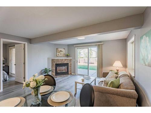 230 Arbour Ridge Park Nw, Calgary, AB - Indoor Photo Showing Living Room With Fireplace