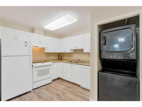 113-5000 Somervale Court Sw, Calgary, AB - Indoor Photo Showing Kitchen With Double Sink