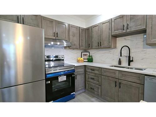 203-1001 68 Avenue Sw, Calgary, AB - Indoor Photo Showing Kitchen With Stainless Steel Kitchen With Double Sink With Upgraded Kitchen