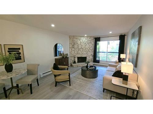 203-1001 68 Avenue Sw, Calgary, AB - Indoor Photo Showing Living Room With Fireplace