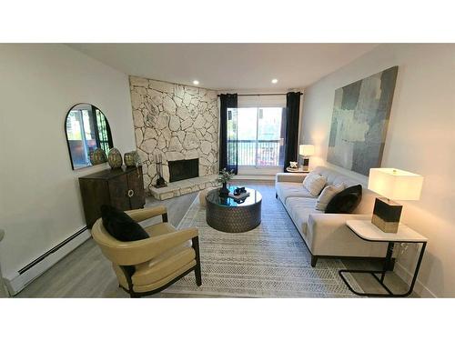 203-1001 68 Avenue Sw, Calgary, AB - Indoor Photo Showing Living Room With Fireplace