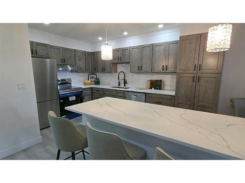 203-1001 68 Avenue Sw, Calgary, AB - Indoor Photo Showing Kitchen With Stainless Steel Kitchen With Upgraded Kitchen