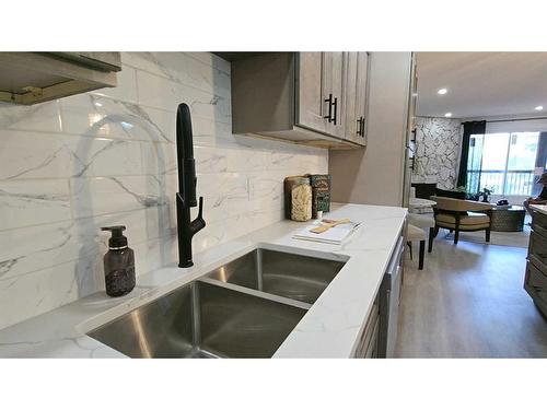 203-1001 68 Avenue Sw, Calgary, AB - Indoor Photo Showing Kitchen With Double Sink