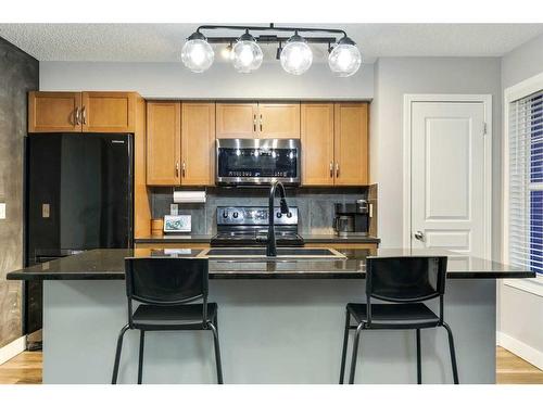 110-250 New Brighton Villas Se, Calgary, AB - Indoor Photo Showing Kitchen With Double Sink