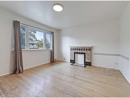 2610 15A Street Sw, Calgary, AB - Indoor Photo Showing Living Room With Fireplace