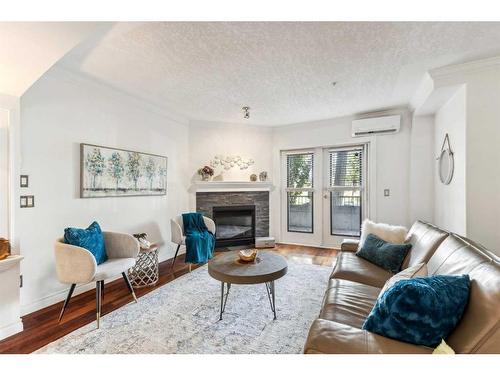 106-59 22 Avenue Sw, Calgary, AB - Indoor Photo Showing Living Room With Fireplace