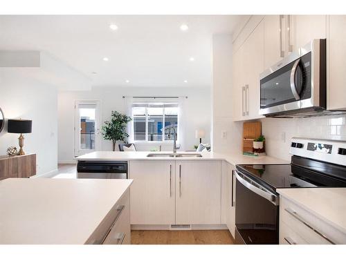 803-280 Chelsea Road, Chestermere, AB - Indoor Photo Showing Kitchen With Stainless Steel Kitchen With Double Sink