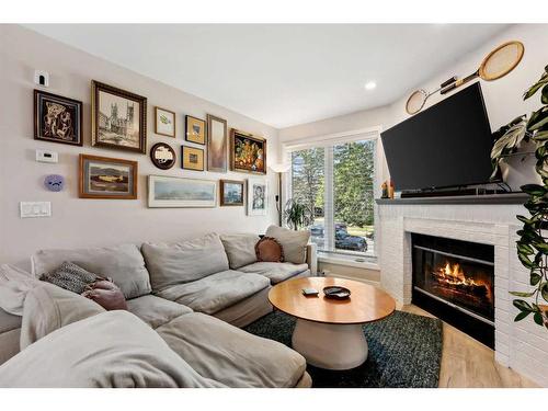 109 Coachway Lane Sw, Calgary, AB - Indoor Photo Showing Living Room With Fireplace