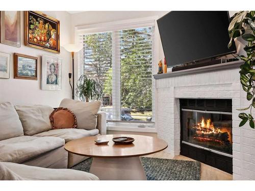 109 Coachway Lane Sw, Calgary, AB - Indoor Photo Showing Living Room With Fireplace