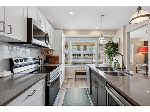 109 Coachway Lane Sw, Calgary, AB - Indoor Photo Showing Kitchen With Stainless Steel Kitchen With Double Sink With Upgraded Kitchen