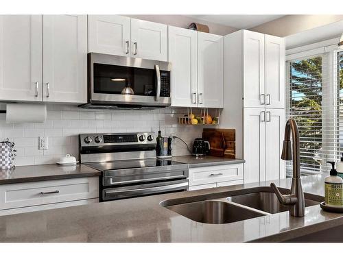 109 Coachway Lane Sw, Calgary, AB - Indoor Photo Showing Kitchen With Stainless Steel Kitchen With Double Sink With Upgraded Kitchen