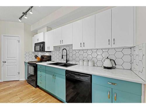 30 Auburn Bay Common Se, Calgary, AB - Indoor Photo Showing Kitchen With Double Sink