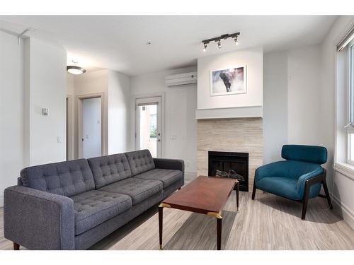 201-518 33 Street Nw, Calgary, AB - Indoor Photo Showing Living Room With Fireplace