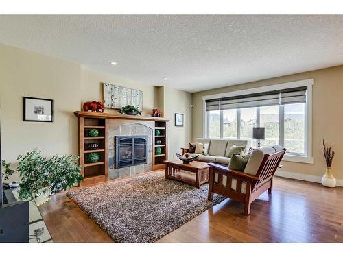 521 Aspen Glen Place Sw, Calgary, AB - Indoor Photo Showing Living Room With Fireplace