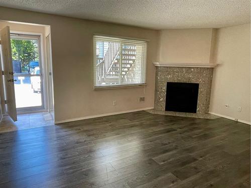 81 Cedar Springs Gardens Sw, Calgary, AB - Indoor Photo Showing Living Room With Fireplace