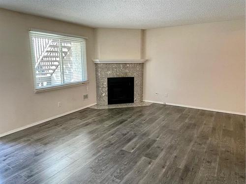 81 Cedar Springs Gardens Sw, Calgary, AB - Indoor Photo Showing Living Room With Fireplace