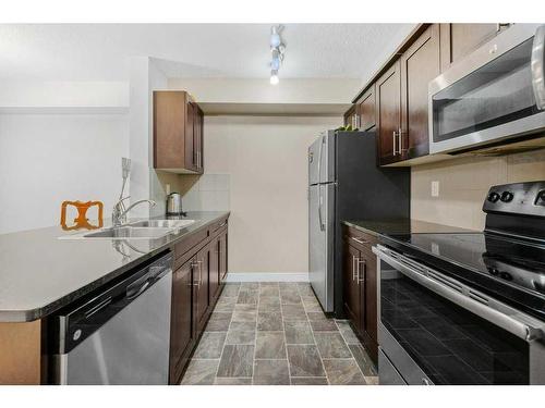 2417-81 Legacy Boulevard Se, Calgary, AB - Indoor Photo Showing Kitchen With Stainless Steel Kitchen With Double Sink