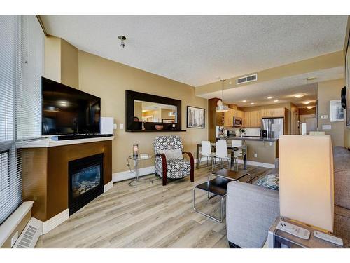 406-55 Spruce Place Sw, Calgary, AB - Indoor Photo Showing Living Room With Fireplace