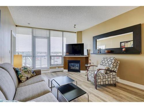 406-55 Spruce Place Sw, Calgary, AB - Indoor Photo Showing Living Room With Fireplace