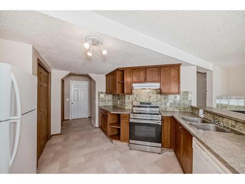 184 Bridlewood Road Sw, Calgary, AB - Indoor Photo Showing Kitchen With Double Sink